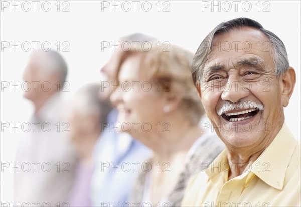 Group of seniors standing in a row. Photo. momentimages