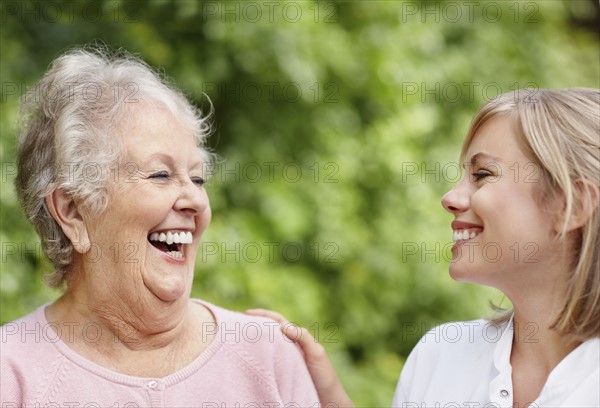 Two women laughing. Photo. momentimages