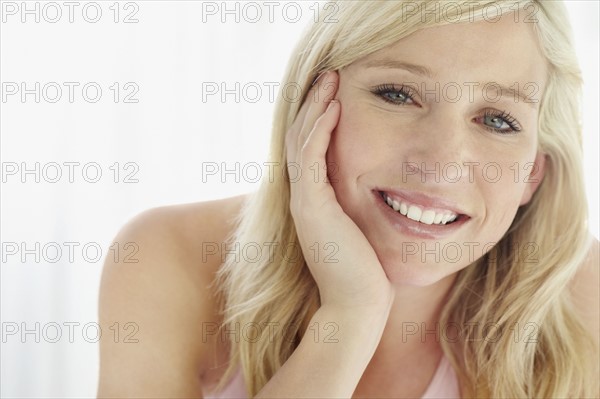 Pretty blond relaxing on bed. Photo. momentimages