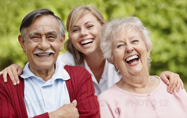 Three people laughing. Photo. momentimages