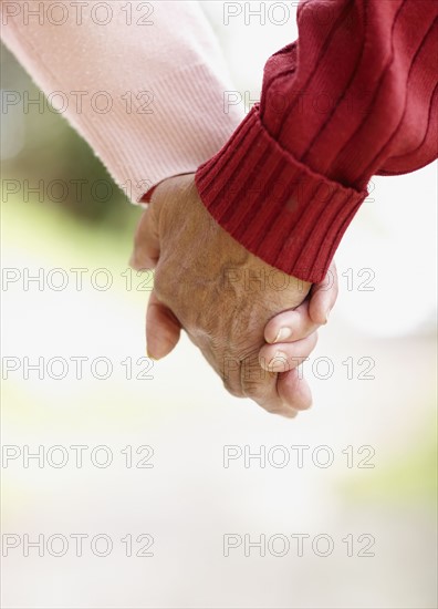 Two people holding hands. Photo : momentimages