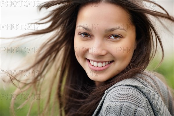 Smiling attractive brunette woman. Photo. momentimages