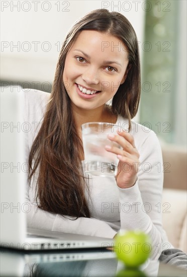 Woman drinking a glass of water. Photo. momentimages