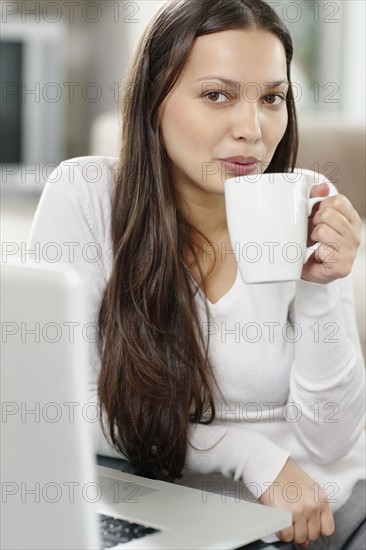 Woman drinking coffee. Photo. momentimages