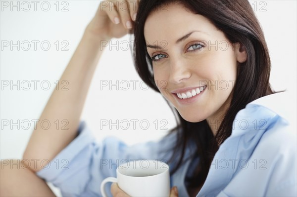 Attractive brunette drinking coffee. Photo. momentimages