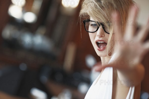 Blond woman shouting. Photo. momentimages