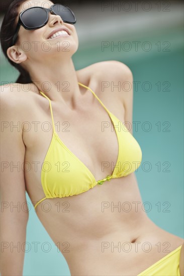 Attractive woman sunbathing. Photo. momentimages