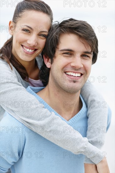 Man giving woman a piggy back ride. Photo. momentimages