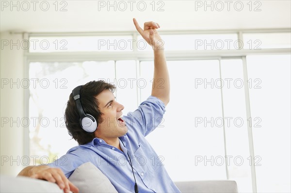 Man listening to music on headphones. Photo. momentimages