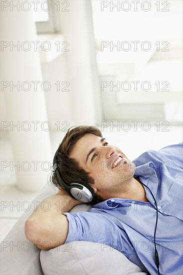 Man listening to music on headphones. Photo. momentimages