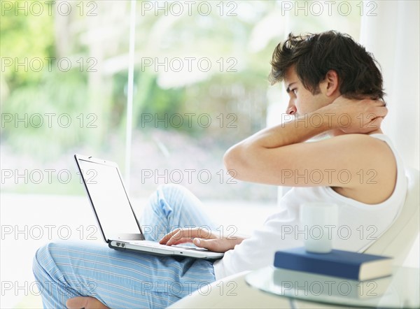Relaxed man browsing the internet. Photo. momentimages