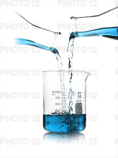 Blue liquid being poured into measuring cup. Photo : David Arky