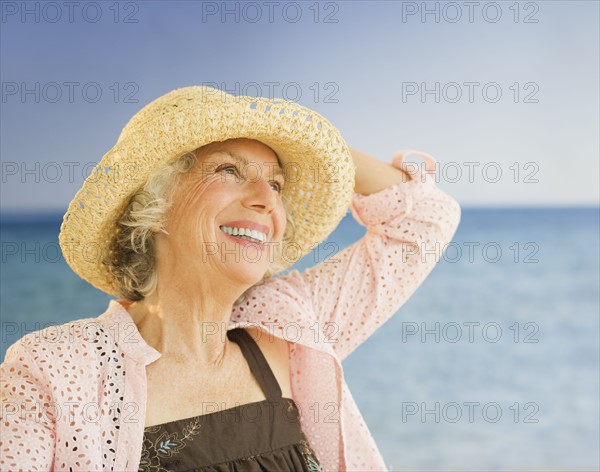 Happy woman at the beach. Photo : Daniel Grill