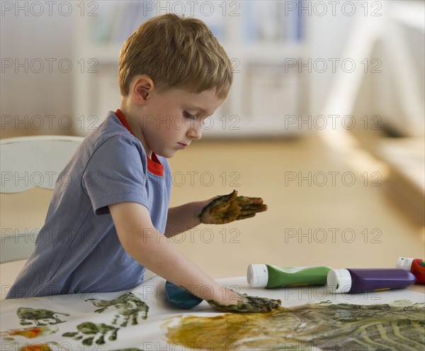 Young boy finger painting. Photo : Daniel Grill