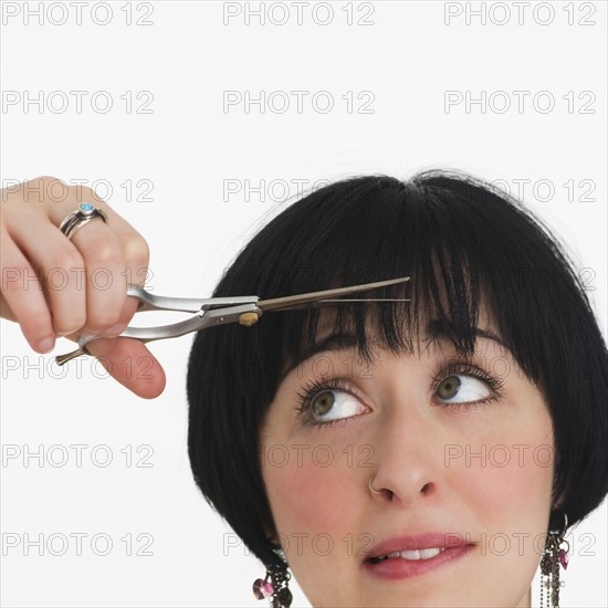 Nervous woman watching her hair being cut. Photo : Daniel Grill