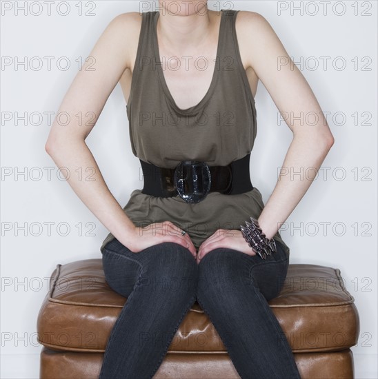 Woman sitting on ottoman. Photo : Daniel Grill