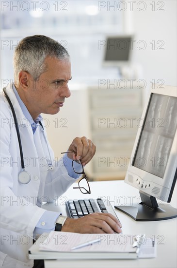 Doctor working on computer.