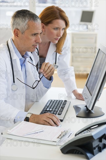Healthcare professionals looking at computer.