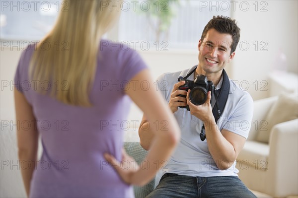 Man taking photograph of woman.