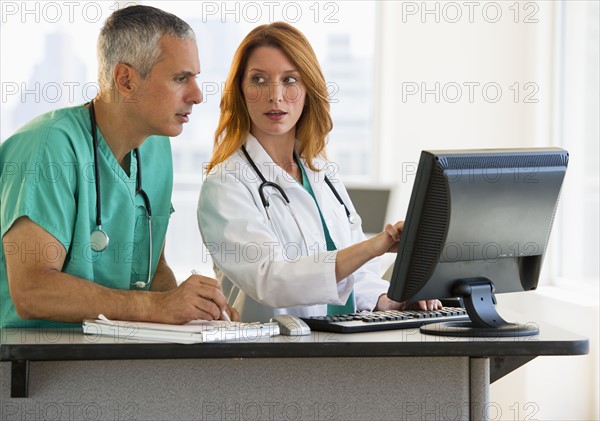 Healthcare professionals working at computer.