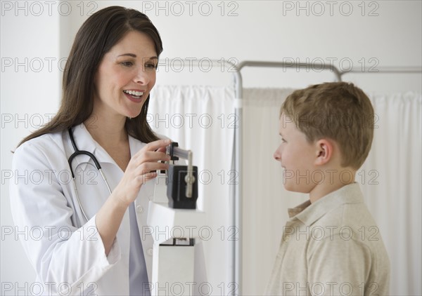 Young boy and doctor in examination room.