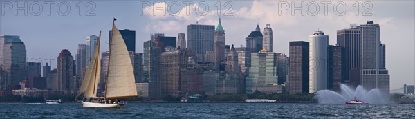 Sailboat on river in front of Lower Manhattan.