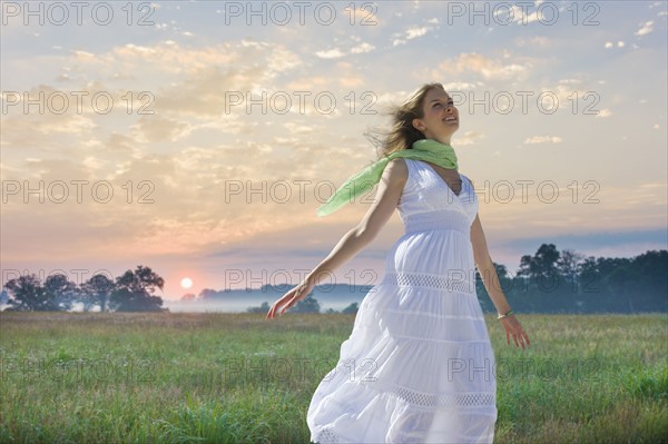 Carefree woman in field.