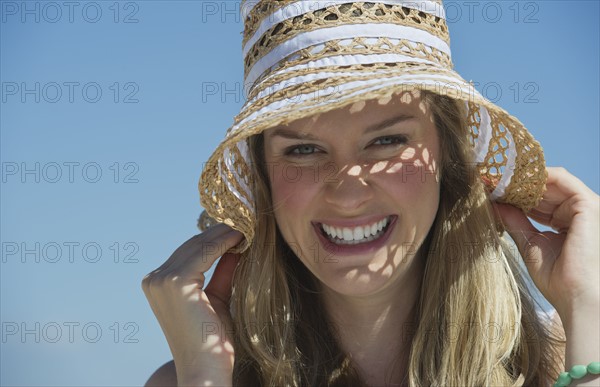 Pretty woman wearing straw hat.