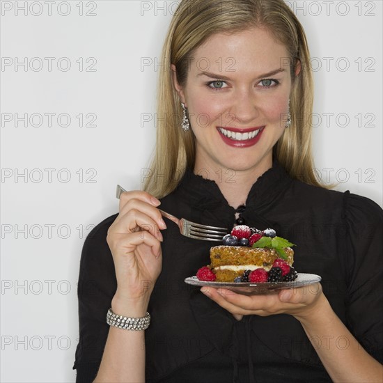 Woman eating decadent dessert.