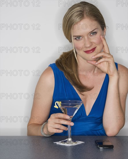 Woman holding a martini glass.