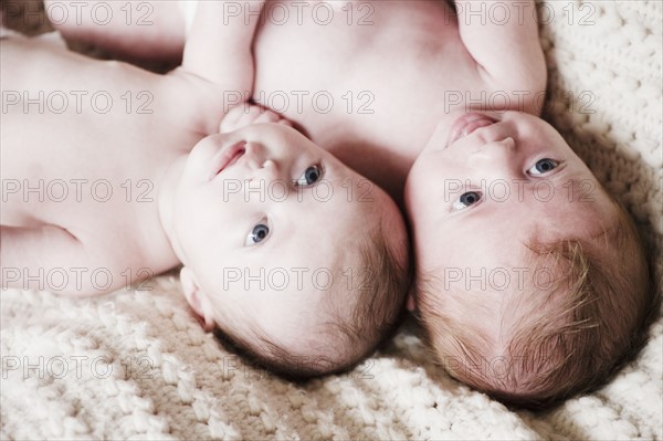 Two babies lying together. Photo. Jamie Grill