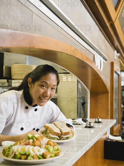 Chef leaning on counter.