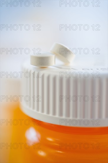 Pills on top of bottle of prescription medication.