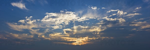 Sunset behind clouds.