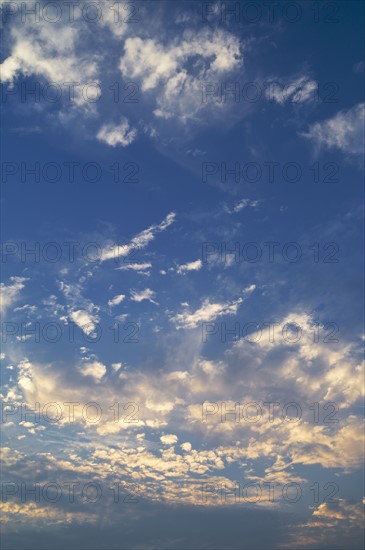 Clouds in blue sky at dusk.