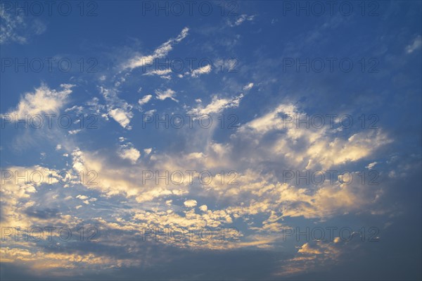 Clouds in blue sky at dusk.