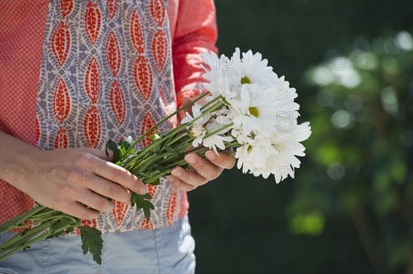 Fresh flowers in woman's hands.