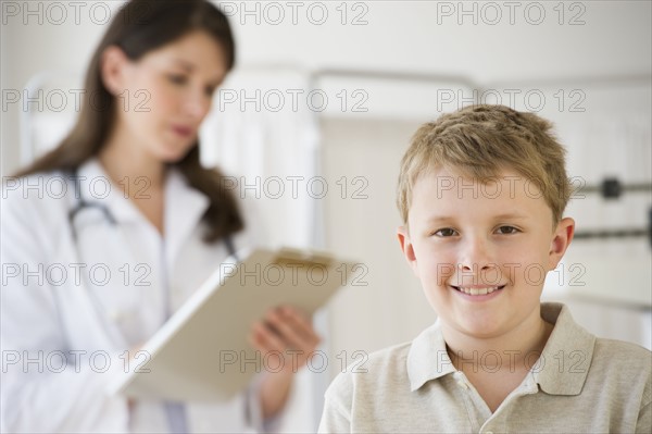 Young boy and doctor in examination room.