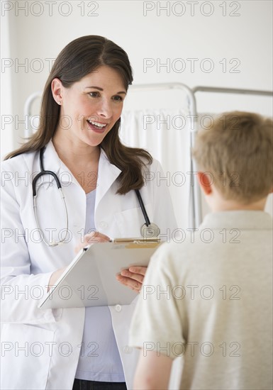 Young boy and doctor in examination room.