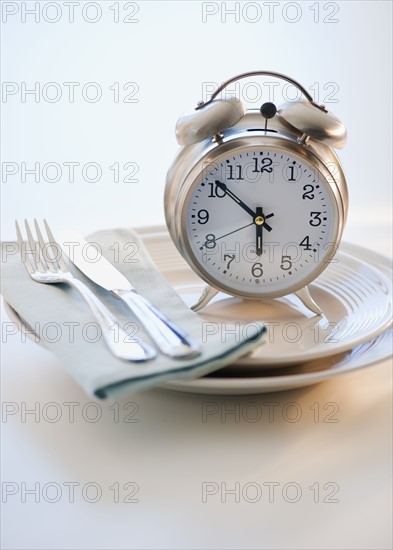 Alarm clock on plate.