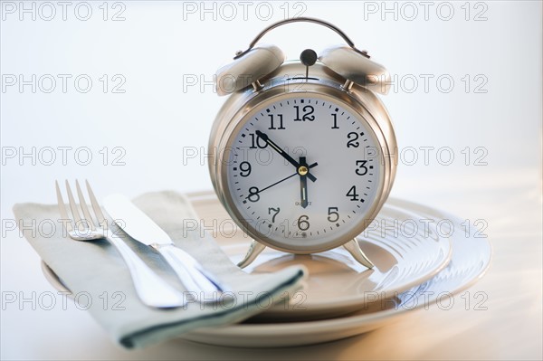 Alarm clock on plate.