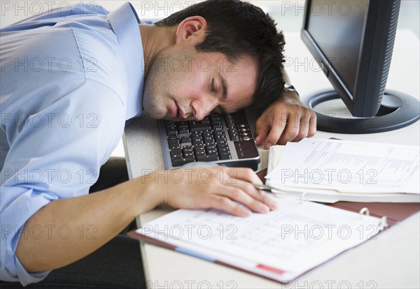 Businessman asleep at his desk.