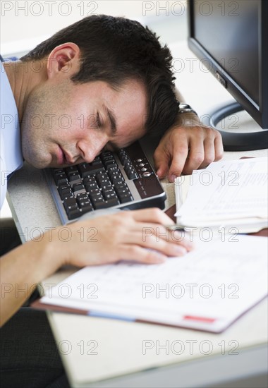 Businessman asleep at his desk.