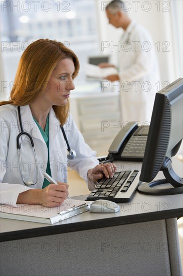 Doctor working on computer.