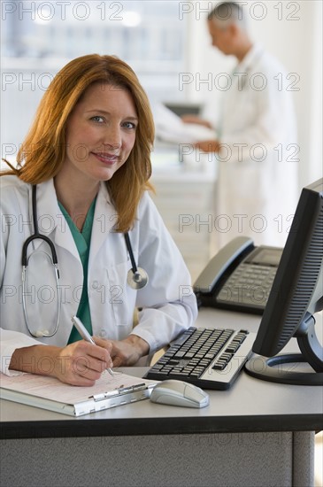 Doctor working on computer.