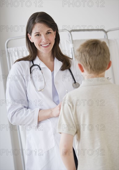 Young boy and doctor in examination room.