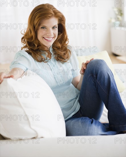 Woman relaxing on couch. Photo : Jamie Grill