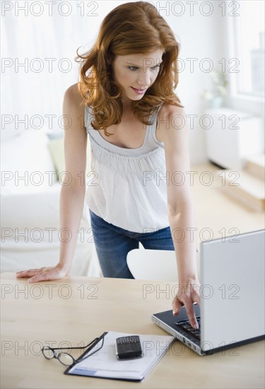 Woman looking at laptop. Photo. Jamie Grill