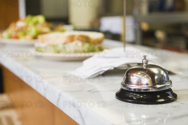 Bell on counter in restaurant.