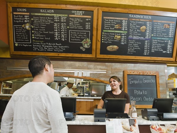 Customer ordering food at bakery.